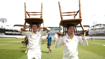 Steve Smith and Marnus Labuschagne carry chairs