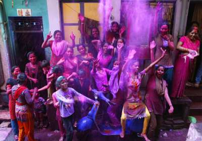 Indian revelers celebrate Holi, the Hindu festival of colors, in Ahmadabad, India. During the festival, people armed with water balloons, colored water and powder in multiple hues play Holi by smearing each other's faces with color. 