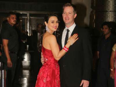 Bollywood actress Preity Zinta and husband Gene Goodenough invited Bollywood stars to a reception in Mumbai on Friday.

Preity was looking gorgeous in a bridal red gown while Gene wore an elegent black suit.