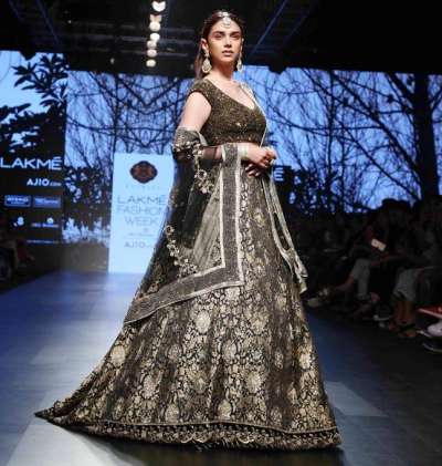 Aditi Rao Hydari walked the ramp in a glittering, black, encrusted lehenga paired with dazzling choli and embellished tulle dupatta.