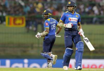 Chamara Kapugedera and Milinda Siriwardana run between the wickets during the second one-day international cricket match against India in Pallekele