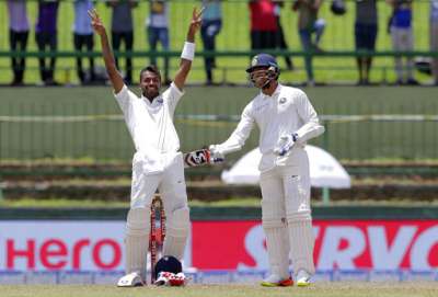 Hardik Pandya gestures towards team's dressing room as he celebrates his maiden Test century during the second day's play against Sri Lanka in Pallekele