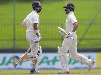 Shikhar Dhawan and Lokesh Rahul run between the wickets during the first day's play of the third Test against Sri Lanka in Pallekele