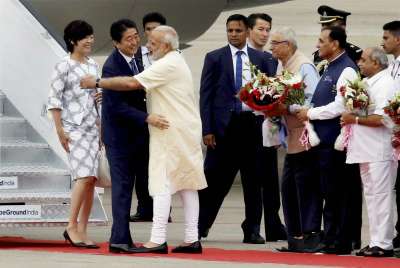 PM Narendra Modi receives his Japanese counterpart Shinzo Abe as he arrives along with his wife Akie Abe at the Ahmedabad airport