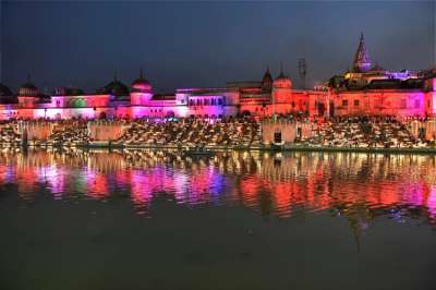 People lighting earthen lamps on banks of River Sarayu during Diwali celebrations in Ayodhya on Wednesday. 