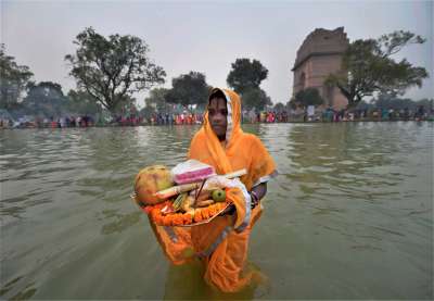 A Devotee pray to Sun God on the occasion of Chhath puja at India Gate, in New Delhi on Thursday