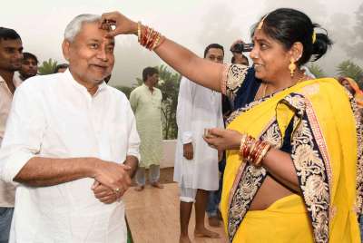 Bihar CM Nitish Kumar's siter applying tikka during Chhath puja at his official residence in Patna on Friday