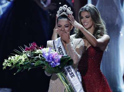 Former Miss Universe Iris Mittenaere, right, crowns new Miss Universe Demi-Leigh Nel-Peters at the Miss Universe pageant on Sunday, in Las Vegas. 
