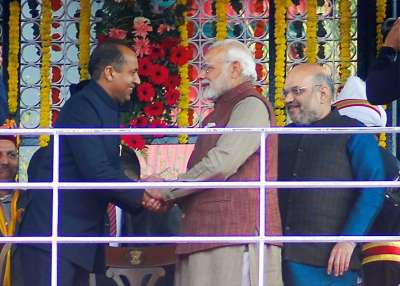 PM Narendra Modi greets the newly sworn-in CM of Himachal Pradesh Jairam Thakur as BJP President Amit Shah looks on, after the oath ceremony at Ridge in Shimla on Wednesday