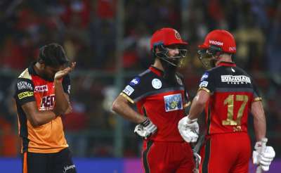 AB de Villiers and Moeen Ali struck breezy half-centuries as Royal Challengers Bangalore held their nerves under pressure to eke out a 14-run win over table-toppers Sunrisers Hyderabad in a must-win match and stay afloat in the Indian Premier League at M. Chinnaswamy Stadium