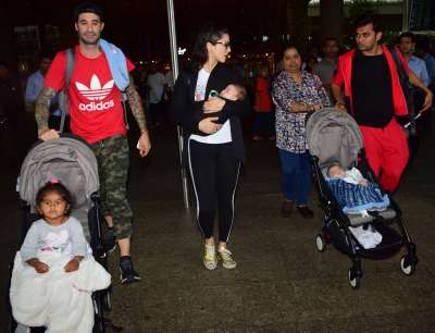 Actress Sunny Leone returned to Mumbai after celebrating her birthday. She was spotted with her husband Daniel Weber and kids Nisha, Noah, Asher.