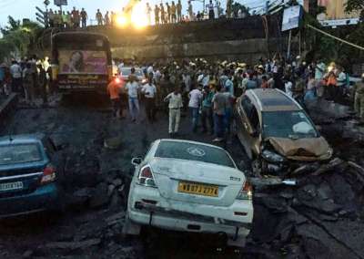 A portion of the arterial Majerhat bridge in south Kolkata collapsed Tuesday evening, snuffing out one life, trapping several people and crushing many vehicles, police said.&amp;nbsp; The 40-year-old bridge in the crowded Alipore area caved in around 4.45 pm during rush hour over rail tracks. It runs over the Majerhat Railway Station and connects the city centre to Behala and other southern suburbs.&amp;nbsp;
&amp;nbsp;
While police confirmed the death of one person, fire brigade personnel engaged in the rescue work said 25 injured were pulled out from the rubble. The injured have been admitted to SSKM and CMRI hospitals, the police said.