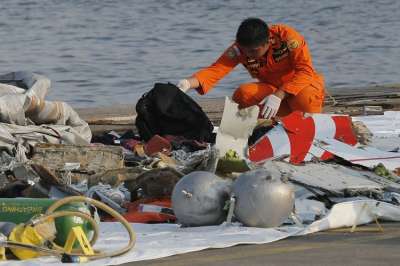 A member of Indonesian Search and Rescue Agency (BASARNAS) inspects debris believed to be from Lion Air passenger jet that crashed off Java Island at Tanjung Priok Port in Jakarta, Indonesia Monday, Oct. 29, 2018. A Lion Air flight crashed into the sea just minutes after taking off from Indonesia's capital on Monday in a blow to the country's aviation safety record after the lifting of bans on its airlines by the European Union and U.S.