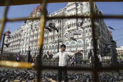 &amp;nbsp;
In this Nov 17, 2018, photo, a man feeds pigeons outside the iconic Taj Mahal Palace hotel, the epicenter of the 2008 terror attacks that killed 166 people in Mumbai, India. Thirty-one people died inside the hotel, including staff trying to guide the guests to safety. Visceral images of smoke leaping out of the city landmark have come to define the 60-hour siege.