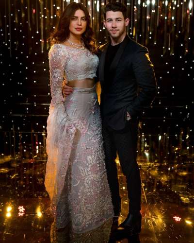 For Nick and Priyanka's third wedding reception, the couple arrived looking nothing short of regal. Priyanka Chopra wore a stunning two-piece covered in intricate beading with lace sleeves by Abu Jani and Sandeep Khosla, while her groom looked dapper in a bottle green suit.
