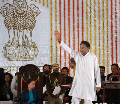 Newly-sworn in Madhya Pradesh Chief Minister Kamal Nath waves at the crowd as Governor Anandiben Patel looks on during the swearing-in-ceremony, in Bhopal