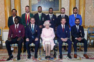 Britain's Queen Elizabeth II joins the captains of the teams taking part in the ICC Cricket World Cup for a photograph in the 1844 Room at Buckingham Palace, before a Royal Garden Party in London.