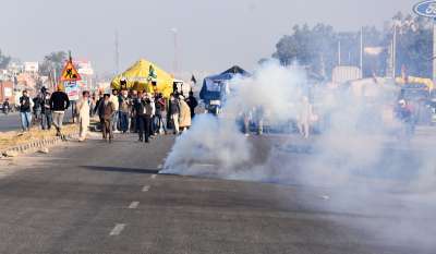 New Delhi: Teargas shells fired by Delhi Police land near protesting farmers to warn them, as they try to cross the border into Delhi during their &quot;Delhi Chalo&quot; protest against Kisan Bill, at Singhu border in New Delhi