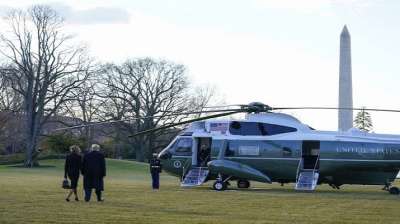 President Donald Trump and first lady Melania Trump walk to board Marine One on the South Lawn of the White House.