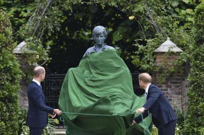 Britain's Prince William, left and Prince Harry unveil a statue they commissioned of their mother Princess Diana, on what woud have been her 60th birthday, in the Sunken Garden at Kensington Palace, London, Thursday July 1, 2021.