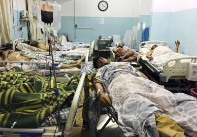 Wounded Afghans lie on a bed at a hospital after a deadly explosion outside the airport in Kabul, Afghanistan, Thursday, Aug. 26, 2021.