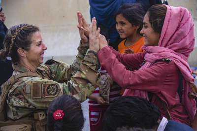 Kabul: In this image provided by the U.S. Marines, a U.S. Airman with the Joint Task Force-Crisis Response high fives a child after helping reunite their family at Hamid Karzai International Airport in Kabul, Afghanistan, Friday, Aug. 20, 2021.