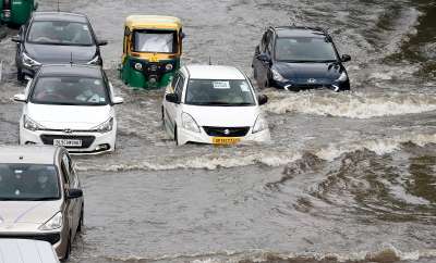 New Delhi: Vehicles wade through a waterlogged road after rain at ITO in New Delhi, Saturday, Aug 21, 2021.