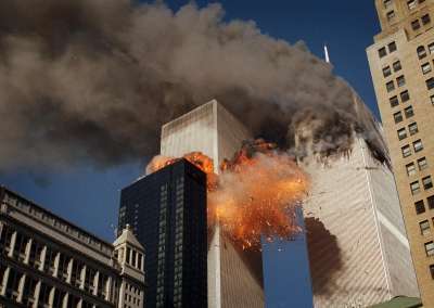Smoke billows from one of the towers of the World Trade Center as flames and debris explode from the second tower, Tuesday, Sept. 11, 2001.