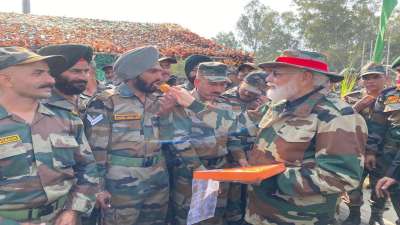 PM Narendra Modi distributes sweets among army soldiers and interacts with them at Nowshera on Diwali.