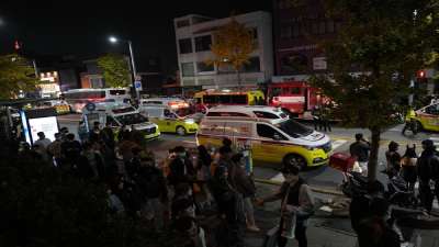 Ambulances carrying victims head to the hospital near the scene in Seoul, South Korea, Sunday, Oct. 30, 2022.