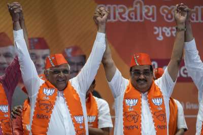 Gujarat Chief Minister Bhupendra Patel, left and Bharatiya Janata Party (BJP) state President C R Patil, celebrate the lead for the party in Gujarat state elections in Gandhinagar, India, Thursday, Dec. 8, 2022. Indian Prime Minister Narendra Modi&rsquo;s Hindu nationalist party is all set to keep its 27-year-old control of his home Gujarat state in a record state legislature win.