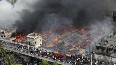 A fire rages at a popular market for cheaper clothes in Bangladesh's capital Dhaka, Bangladesh, Tuesday, April, 4, 2023. The fire broke out at Bangabazar Market in Dhaka on Tuesday, but no casualties were reported immediately. 