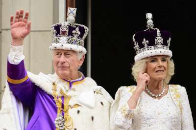 Britain's King Charles III and Queen Camilla wave to the crowds from the balcony of Buckingham Palace after the coronation ceremony in London.