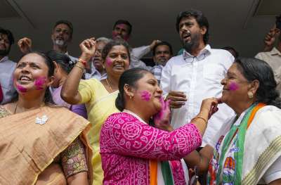  Congress leaders and workers celebrate at the party office in Bengaluru.