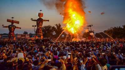People watch an effigy of Hindu demon king Ravana, Meghanada and Kumbhkaran, stuffed with firecrackers, burning on Dussehra in Amritsar
