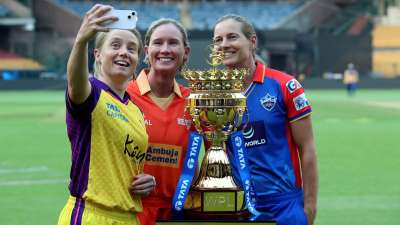 UP Warriorz's captain Alyssa Healy, Gujarat Giants' Beth Mooney and Delhi Capitals' veteran Meg Lanning with the WPL 2024 trophy at Bengaluru's M Chinnaswamy Stadium on Wednesday. Last edition's finalists Mumbai Indians and Delhi Capitals will clash in the season opener on Friday, February 21. 