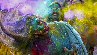 Women drenched in colours celebrate Holi in West Bengal's Nadia.