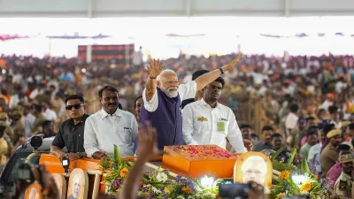 PM Modi waves at supporters as he arrives for a public meeting ahead of Lok Sabha elections, in Salem, Tamil Nadu.