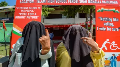 Anantnag: Women show their ink marked fingers after casting votes at a polling station during the sixth phase of Lok Sabha elections, in Anantnag district of south Kashmir, Saturday, May 25, 2024. 