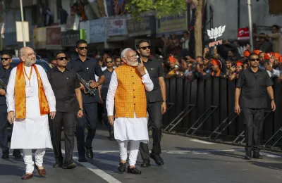 Prime Minister Narendra Modi leaves after casting his vote at a polling station during the third phase of Lok Sabha elections