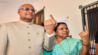 After casting their votes in Mumbai, Maharashtra Governor Ramesh Bais and his wife show their fingers marked with indelible ink.