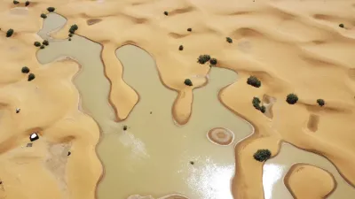 Pools of water caused by heavy rainfall between sand dunes are visible in the desert town of Merzouga, Morocco.