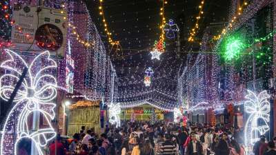 In Kolkata, residents of the Anglo-Indian community's Bow Barracks celebrate Christmas with festive decorations and vibrant lights. The area shines brightly, attracting visitors to experience the holiday spirit on Christmas Eve.