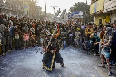 An artist dressed as Lord Shiva holding a big Trishul performs during the royal entry procession or Chavni Pravesh of Niranjani Akhara for the Mahakumbh 2025, at Sangam in Prayagraj.