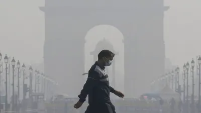 India stands at number 1 in ranking with PM 53.3. In the image a pedestrian wearing a face mask at Kartavya Path as air quality deteriorates in Delhi. 