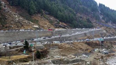 Hundreds of tourists were stuck in traffic jams in Himachal Pradesh's Manali after tribal areas and other higher reaches in Solang Valley received light snowfall.  