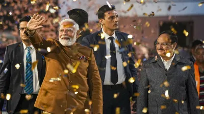 Prime Minister Narendra Modi greets supporters at the BJP headquarters in New Delhi. Addressing the workers and voters, PM Modi said BJP's &quot;historic&quot; win has ushered in a festival of victory and relief of getting rid of &quot;AAP-da&quot; (disaster) among the people of Delhi.