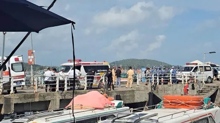 Ambulances line up on a pier to help victims of a boating