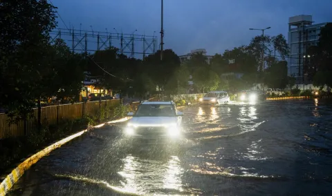 Vehicles wade ahead of the impending landfall of cyclonic