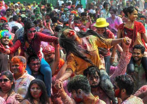 People dance during 'Rangotsav 'as they celebrate the